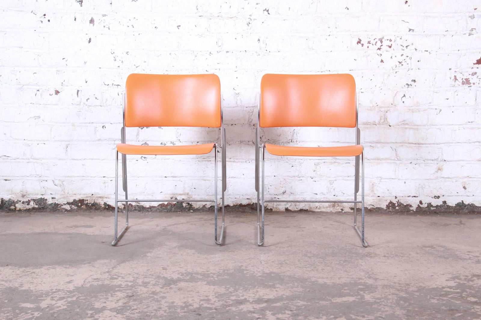 David Rowland 40/4 Orange and Chrome Stacking Chairs: Vintage 40/4 orange and chrome stacking chairs Designed by David Rowland USA 1977 Chrome + orange powder-coated steel Measures: 20.13"W x 21.5"D x 29.88"H. Seat height is 18.5". Very good original vin