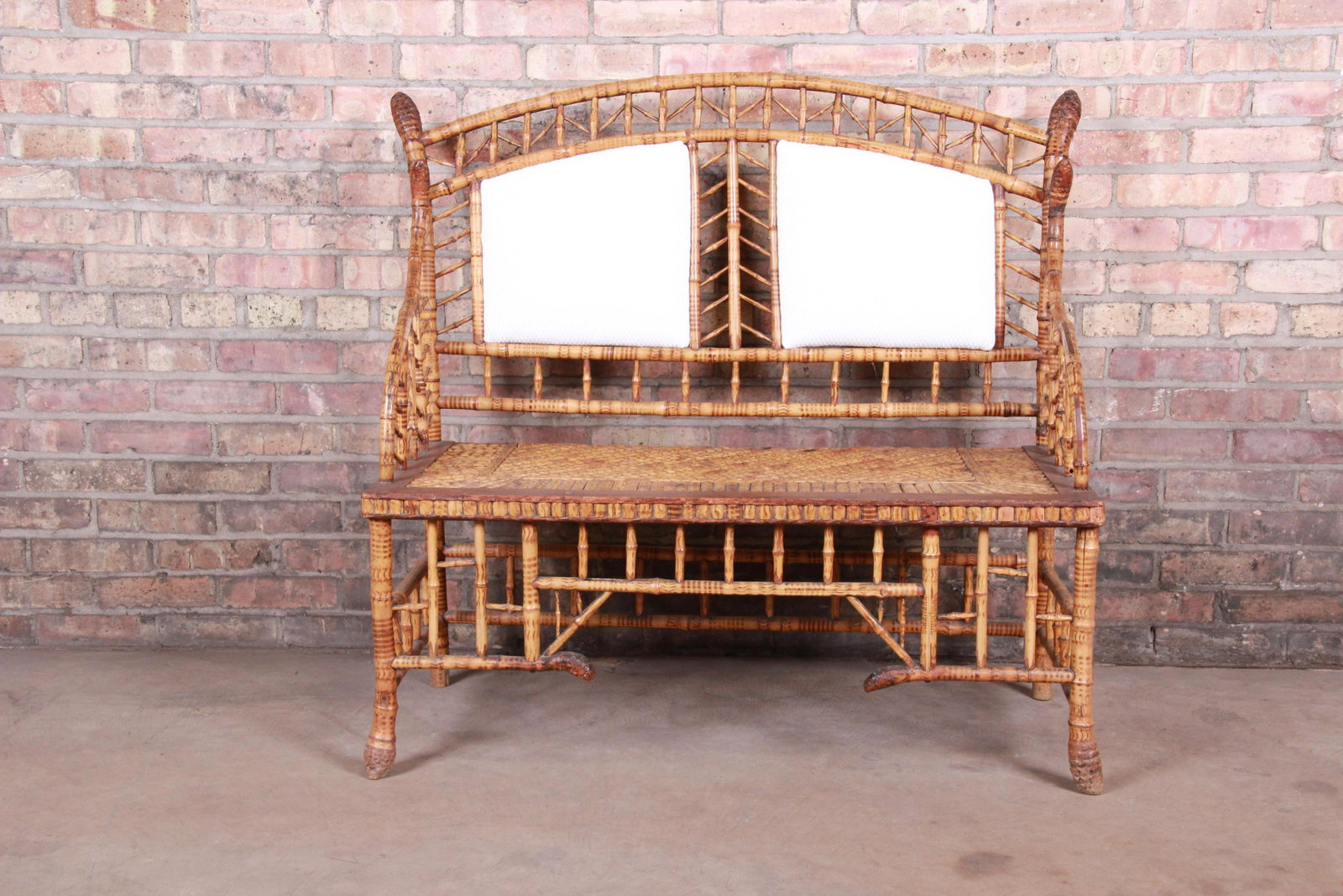 19th Century Victorian Bamboo Settee: A stunning antique Victorian settee or love seat USA 19th Century Bamboo and hardwood with newer upholstered back panels. Measures: 42.75"W x 22"D x 38.5"H. Seat height 16"; arm height 25". Good vinta