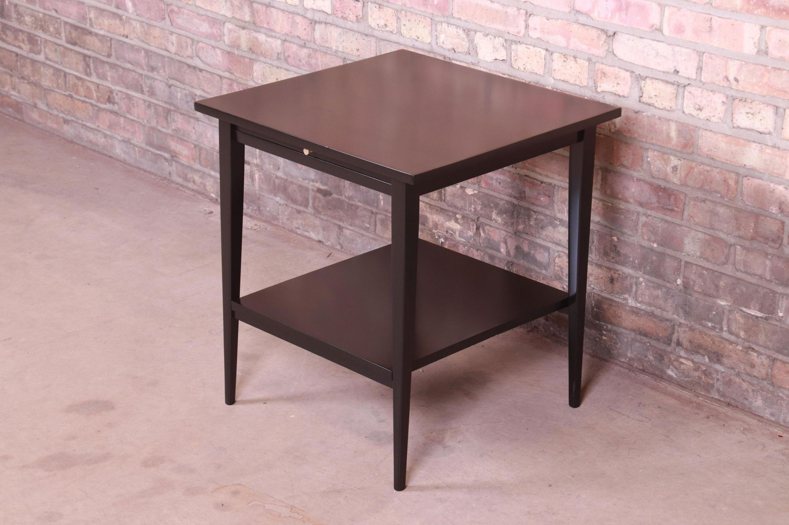 Paul McCobb Planner Group Mid-Century Modern Black: A sleek and stylish mid-century modern nightstand or side table By Paul McCobb for Winchendon Furniture "Planner Group" USA 1950s Black lacquered maple with original brass pull. Measures: 22"W x 21.13