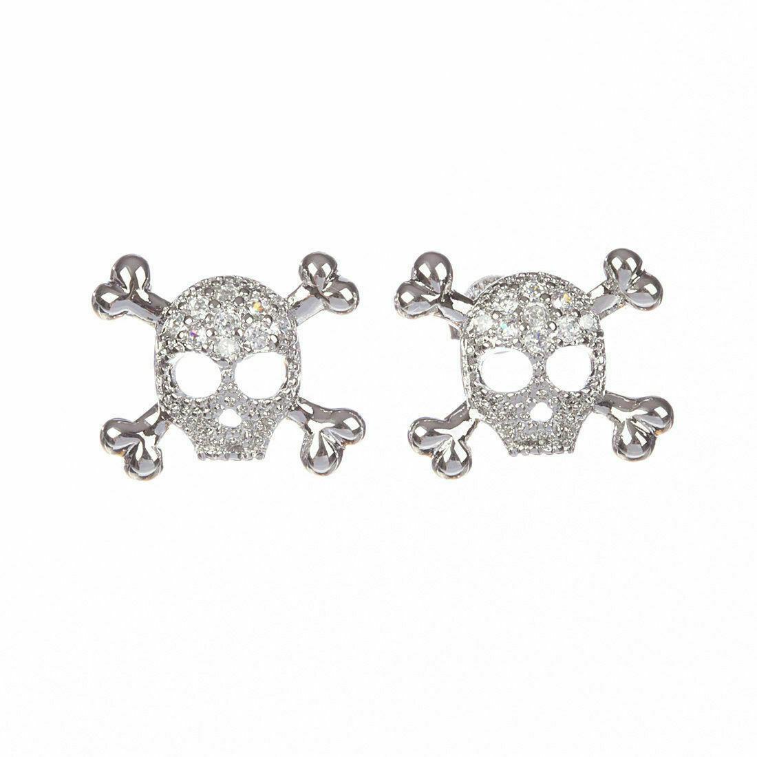 Sterling Silver Skull and Cross Bones Cubic Zirconia: Amazing and unique earrings.Dead stock vintage.Circa 1980's.Earrings measure 16.5 mm's by 13 mm's.The pair weighs 2.3 grams.Marked "925" for sterling silver and acidtested.Earrings are for pierced ear