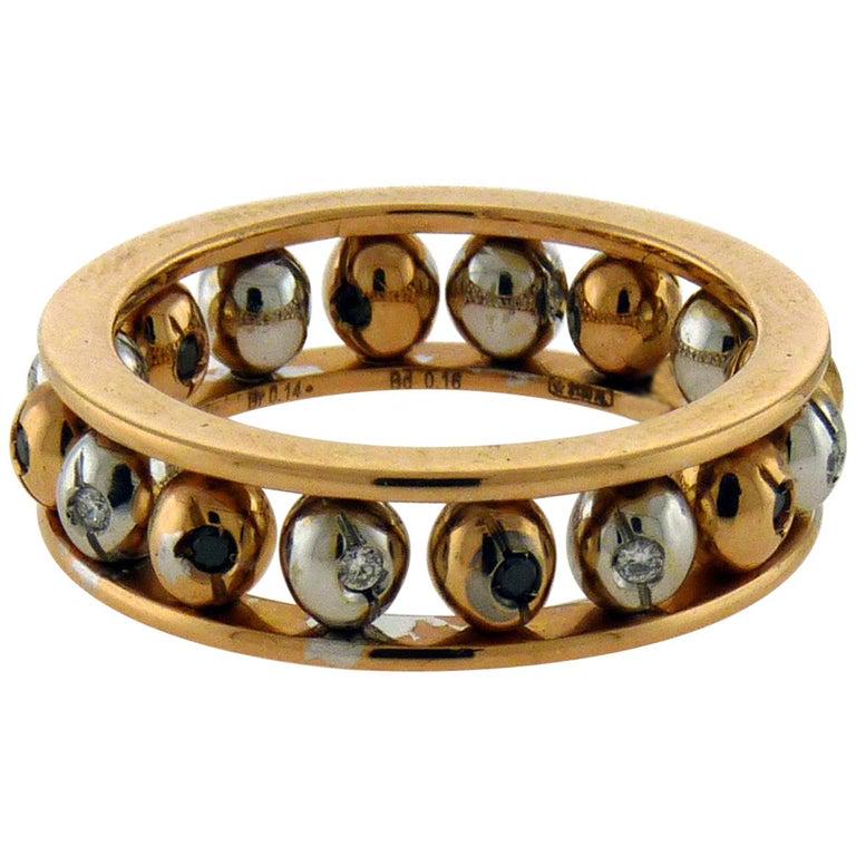 Authentic Crivelli 18 Karat Gold Diamond Rolling Balls: A cool and fashionable Crivelli ring as rolling balls mounted in 18k gold. The bolls are in withe and rose gold. The white gold ones are set in the center with white diamonds and the rose gold ones ar