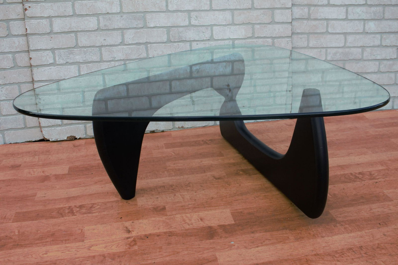 Mid Century Modern Noguchi Style Coffee Table with: Mid Century Modern Noguchi Style Coffee Table with Black Base Glass is about 1” thick. W 50 D 37 H 16 Good vintage condition All Bidhaus items come with a 100% money-back guarantee that the item
