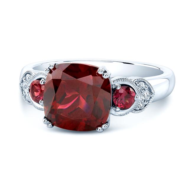 Rhodolite Garnet And Diamond Ring In 14k White Gold: 14k White Gold 1 Cushion Rhodolite Garnet=9mm, 2 Round Rhodolite Garnet, 6 Round Brilliant=0.05ctw Ring Tag Description: 14KW RING 1CURG=9M(4.81CT) 2RDRG=3MM 6RB=0.05CTW Size customizable: Y All Bidha