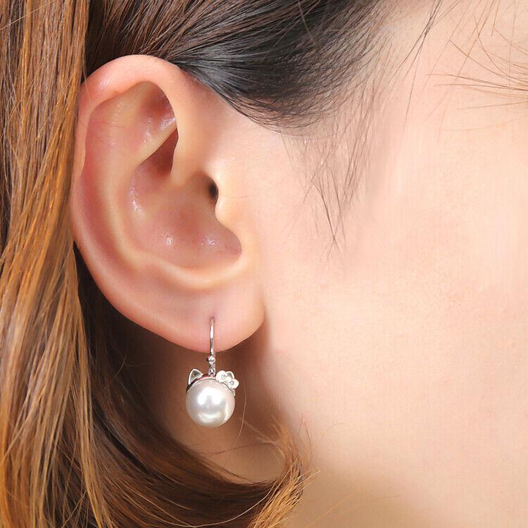 Authentic Sanrio Earrings Hello Kitty Cat Ear Ladies: Condition: New Item size is 23mm 10mm Materials: Body: 925 silver Synthetic Pearl Pink gold color (pink gold plated) Silver color (rhodium plating) What you see in the pictures is all you receive. Pic