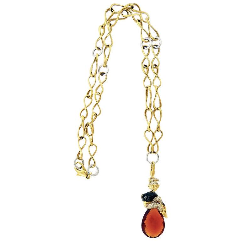 Authentic Crivelli Diamond Brown Topaz Elf Pendant: A cute necklace featuring an elf pendant embellished with brown topaz and diamonds. The metal is 18K two-tone gold. The necklace is 12.75 inches long. Retail price: $18 040. Made by Crivelli in Italy.