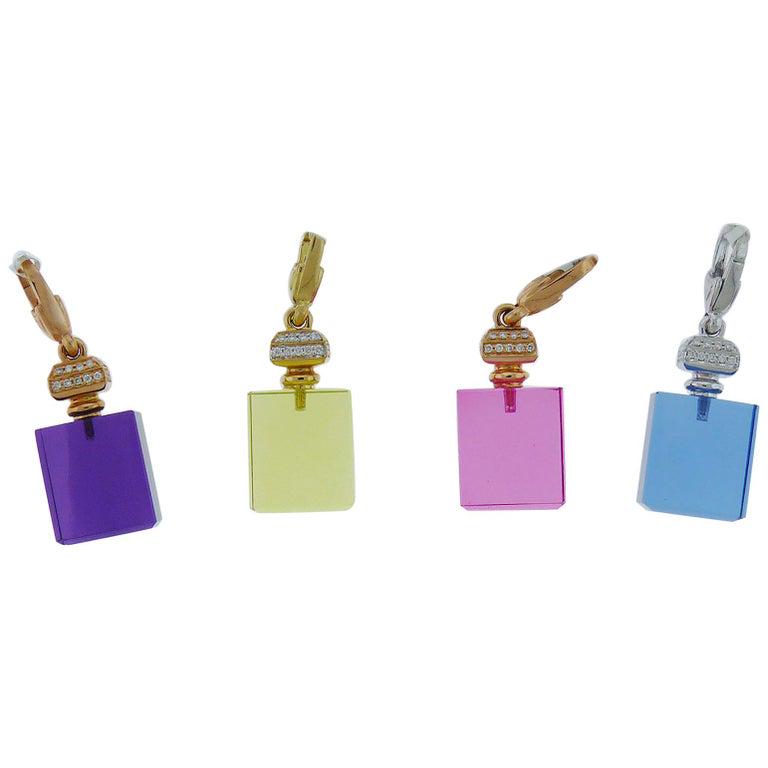 Authentic Crivelli Perfume Bottle Pendants: Four pendants in the shape of perfume bottles in purple pink yellow and blue colors. Made of quartz 18K yellow rose or white gold and embellished with white diamonds. The cord is NOT included. The pen