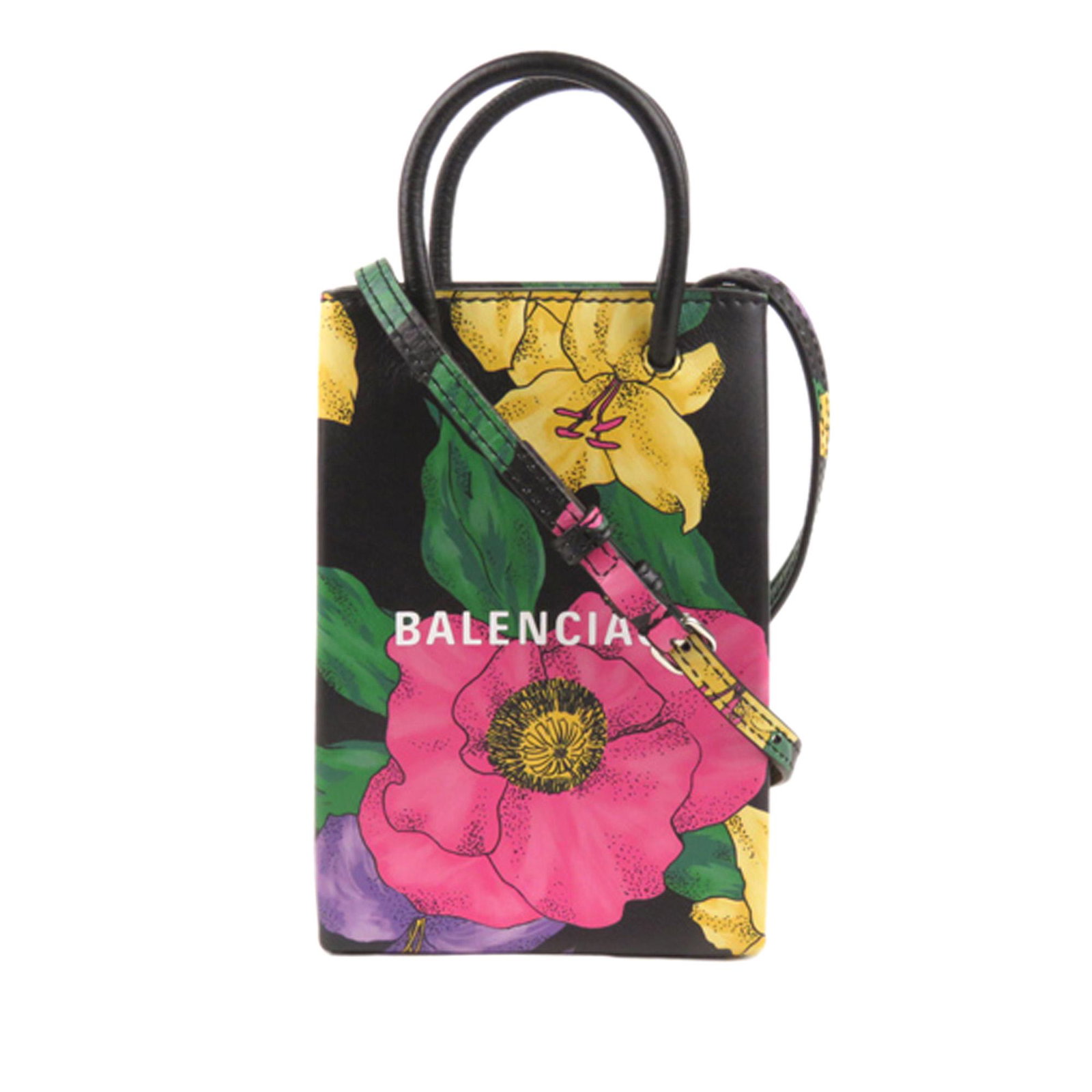 Authentic Balenciaga Floral Shopping Phone Holder: This satchel features a printed leather body rolled leather handles a flat leather strap and an open top. Brand: Balenciaga Model: Floral Shopping Phone Holder Leather Satchel Origin: Spain Category: 