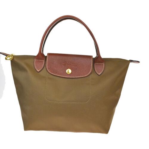 Authentic Longchamp Le Pliage Nylon Leather Handbag: Brand: Longchamp Closure: Snap (hook) Zipper Material: Nylon Leather Occasion: Business Style: Handbag Country/Region of Manufacture: China Color: Brown Personalize: No Department: Women Year Manufact