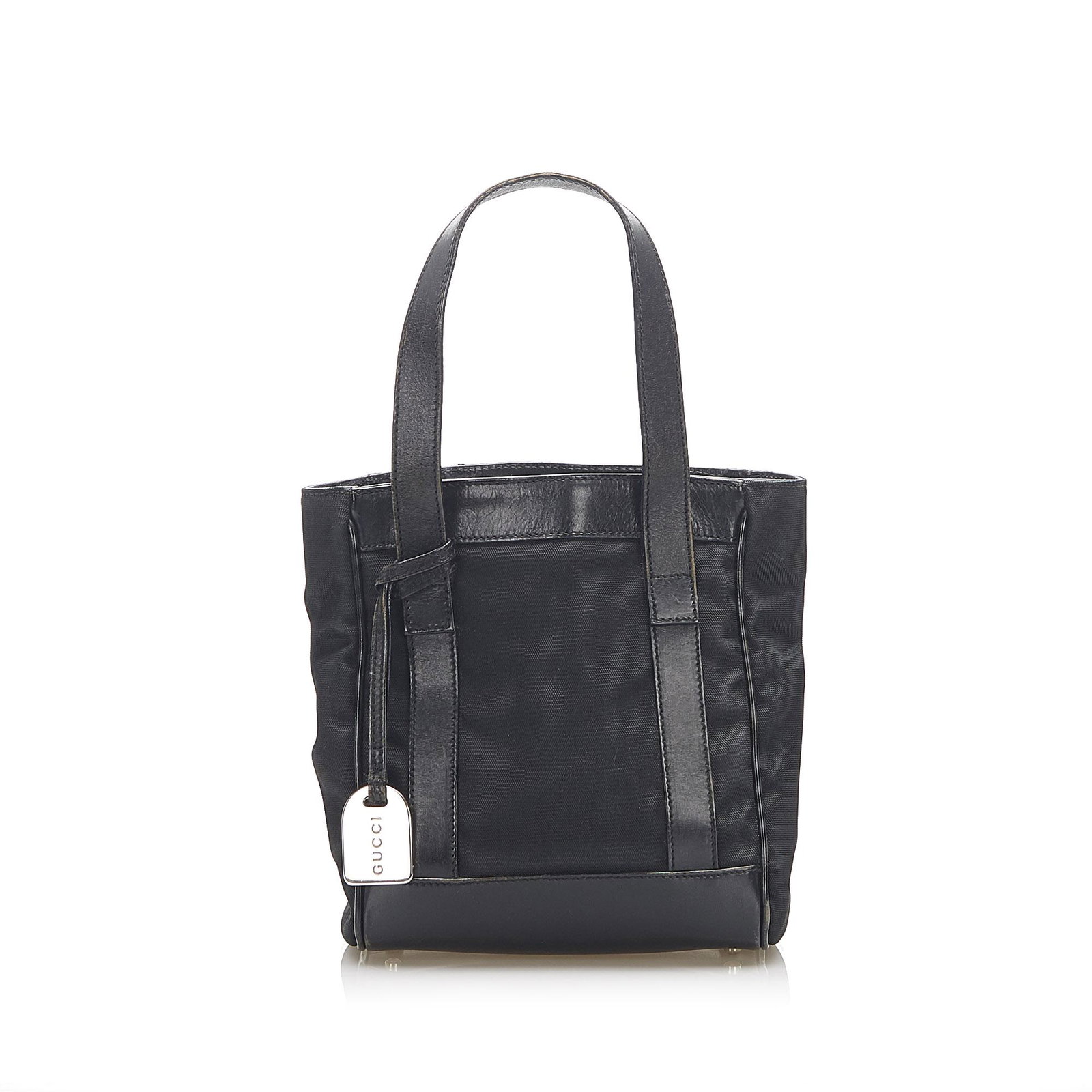 Authentic Gucci Nylon Tote Bag: This item qualifies for FREE DOMESTIC SHIPPING to customers in the USA This tote features a nylon body with leather trim flat leather shoulder straps an open top with a magnetic closure and an interio