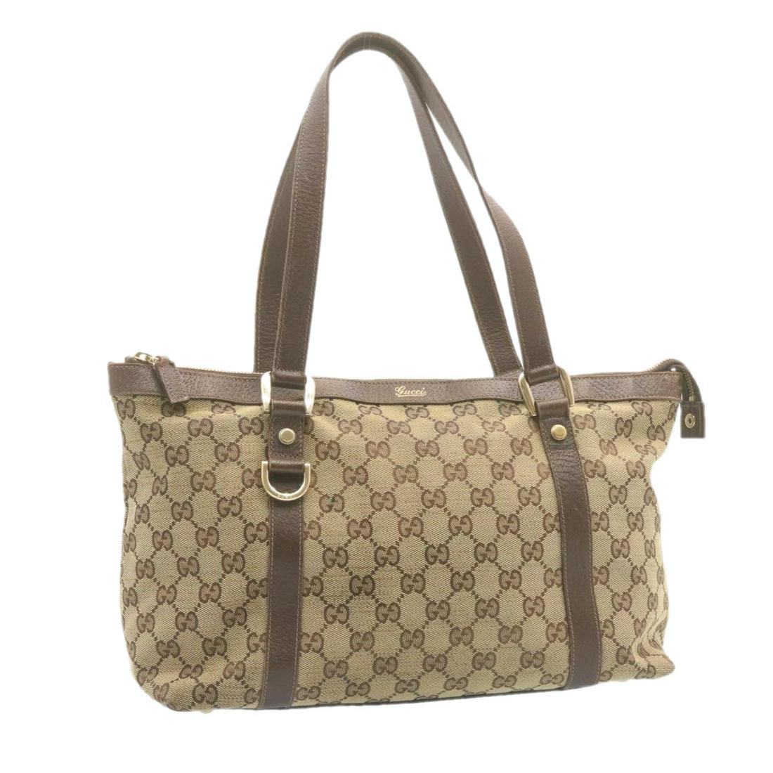 Authentic GUCCI GG Canvas Tote Bag Beige Brown: This item qualifies for FREE DOMESTIC SHIPPING to customers in the USA Brand: GUCCI Style: Tote Bag Material: Canvas Color: Beige Made In: Italy Size (Inches): W14.17 x H8.66 x D4.72inch(Approx) Exter