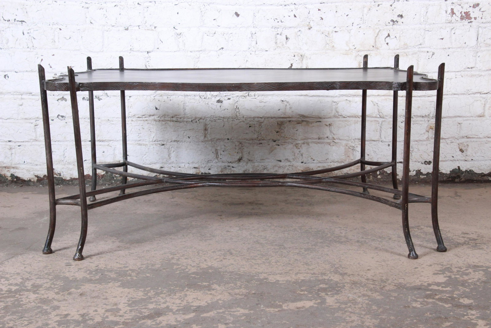 Spanish Revival Leather and Sculptural Forged Steel: Please see Disclaimer for shipping cost estimates. A gorgeous Spanish Revival style coffee or cocktail table in sculptural forged steel and leather By Sarreid Ltd. Circa 1990s Measures: 49"W x 38.25"D
