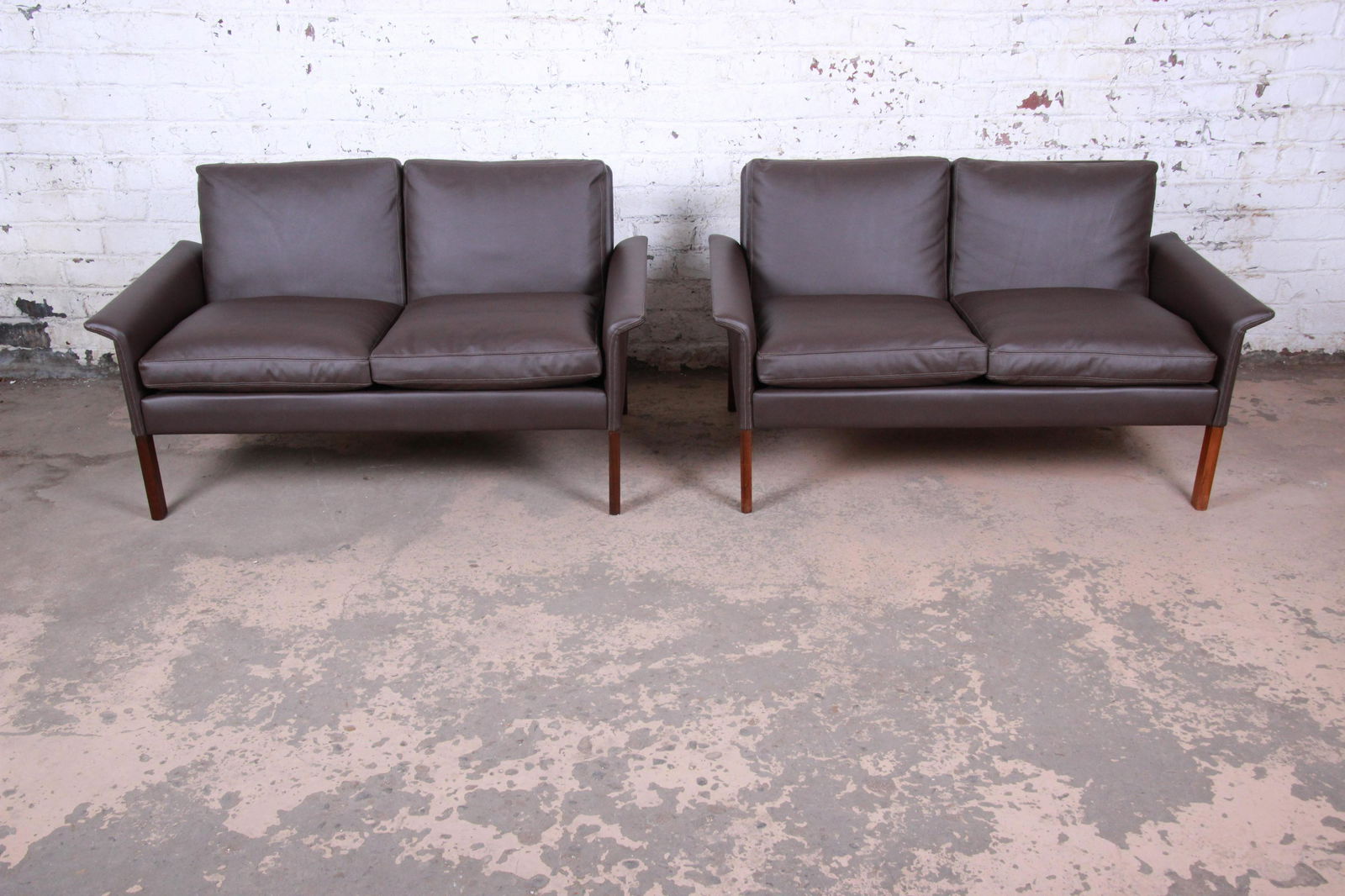 Hans Olsen Danish Modern Rosewood and Leather Settees: Please see Disclaimer for shipping cost estimates. An exceptional pair of mid-century Danish Modern settees or loveseats Designed by Hans Olsen for Christian Sorensen Denmark 1960s Brown leather + ros