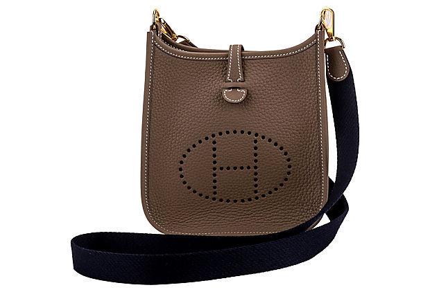 Authentic Hermes Mini Evelyne Etoupe Blue Gold: This item qualifies for FREE DOMESTIC SHIPPING to customers in the USA Condition: New Era: Contemporary; 2000s Dimensions: 6.5" L x 2" W x 8" H Materials: leather fabric metal Color: etoupe navy blue 