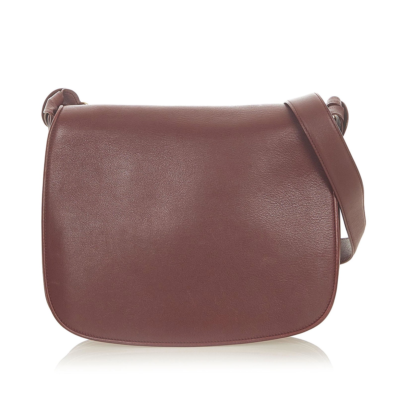 Authentic Must de Cartier Leather Crossbody Bag: This item qualifies for FREE DOMESTIC SHIPPING to customers in the USA This crossbody bag features a leather body an adjustable flat strap a front flap with magnetic closure and an interior zip pocket