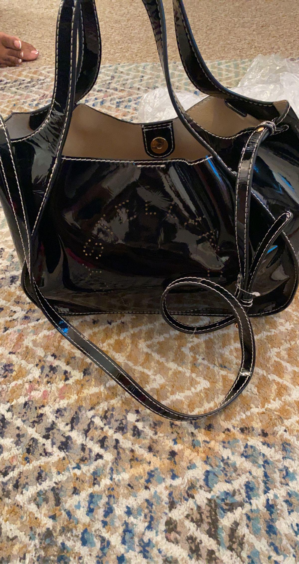 Authentic Stella McCartney Perforated Logo Satchel: This item qualifies for FREE DOMESTIC SHIPPING to customers in the USA This satchel features a faux patent leather body flat handles an adjustable flat strap an open top with magnetic snap button clos