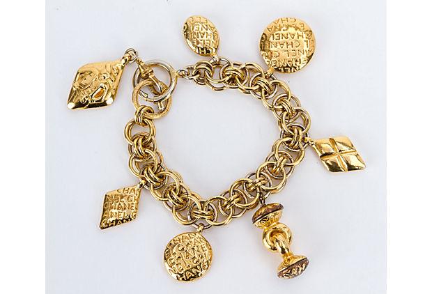 Authentic Chanel 70s Charm Seals Gold Bracelet: This item qualifies for FREE DOMESTIC SHIPPING to customers in the USA Condition: Good; minor tarnish and fading Era: Vintage; 1970s Dimensions: 7" L x 1" W Materials: metal Color: gold Chanel 70s coi