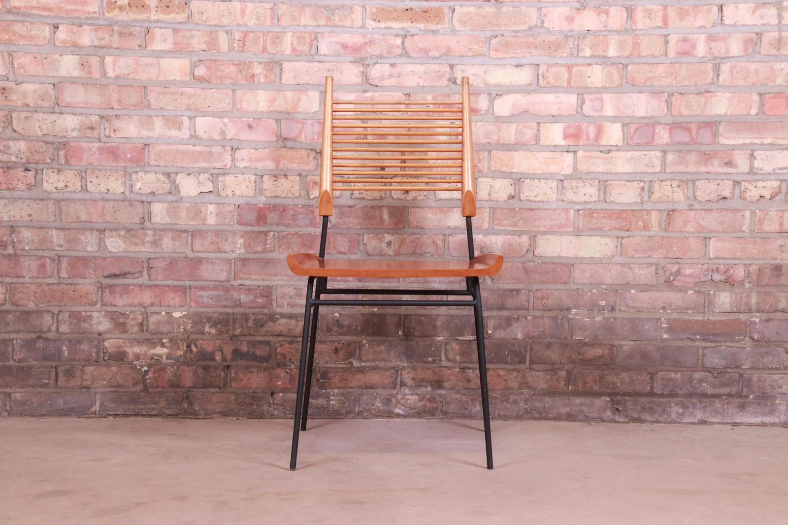 Paul McCobb Maple and Iron "Shovel" Chair Newly: An exceptional mid-century modern "shovel" dining chair or side chair By Paul McCobb for Winchendon Furniture "Planner Group" USA 1950s Sculpted solid maple seat and back support with black iron frame
