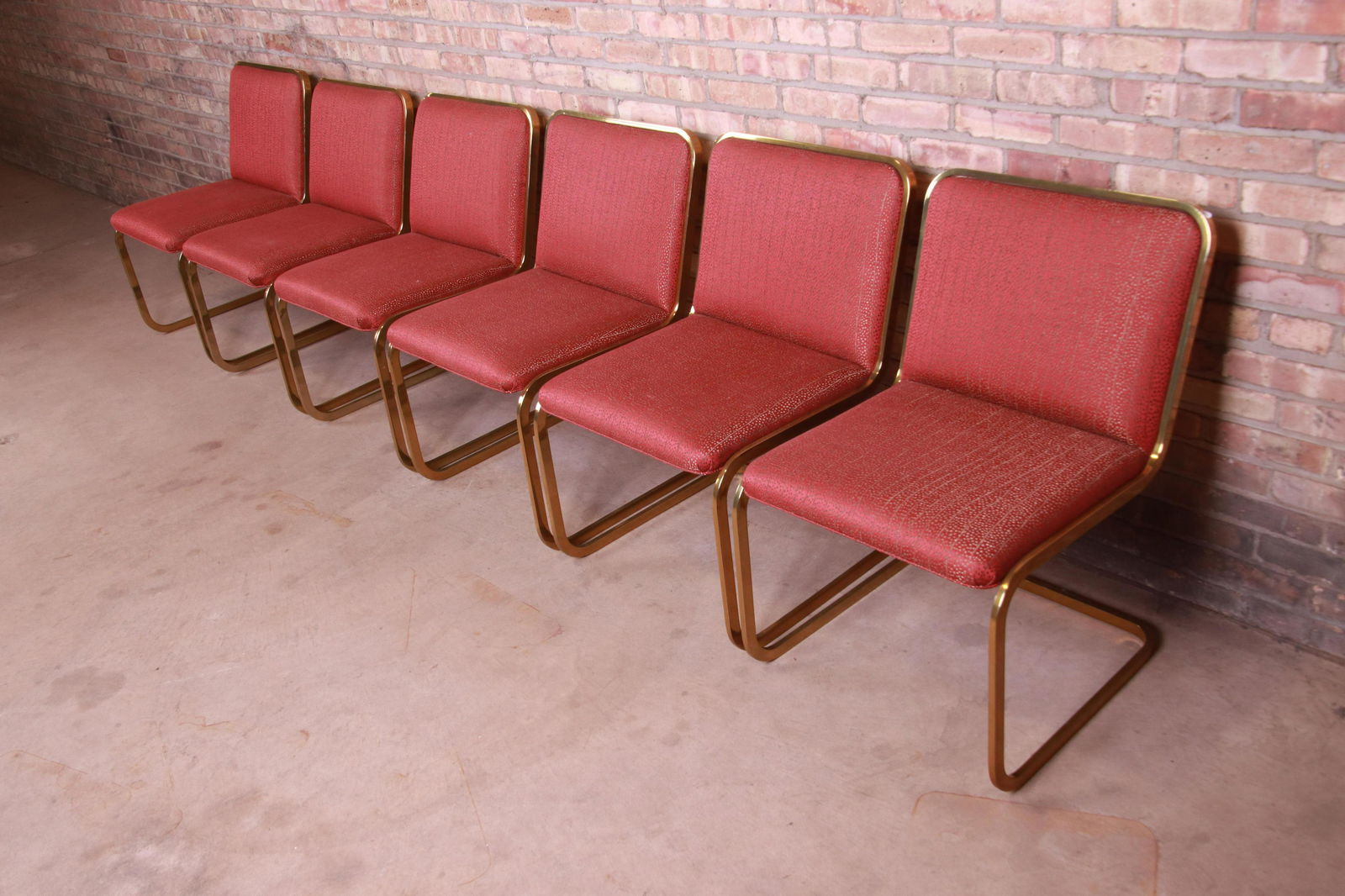 Brueton Mid-Century Modern Hollywood Regency: A gorgeous set of six mid-century modern Hollywood Regency dining chairs In the manner of Milo Baughman By Brueton USA 1970s Cantilevered brass frames with stylish red and gold upholstery. Measures: 2