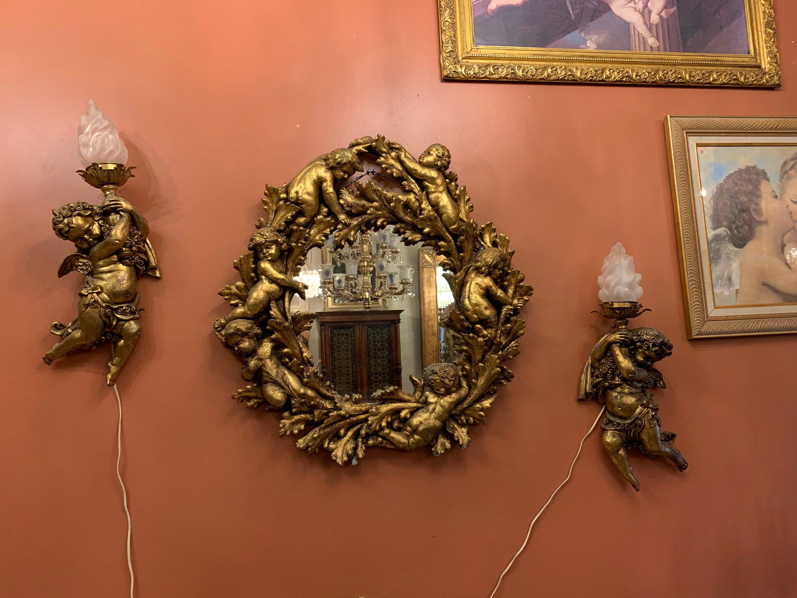 Antique Gold Figural Cherub Mirror with Cherub Wall: Antique Gold Figural Cherubs Mirror with 2 Cherubs Wall Sconces - 3 Piece Set Circa 1920 Mirror H 35 W 35 D 4.5 Sconce #1 H 21 D 6 W 13 Sconce #2 H 21 D 6 W 10