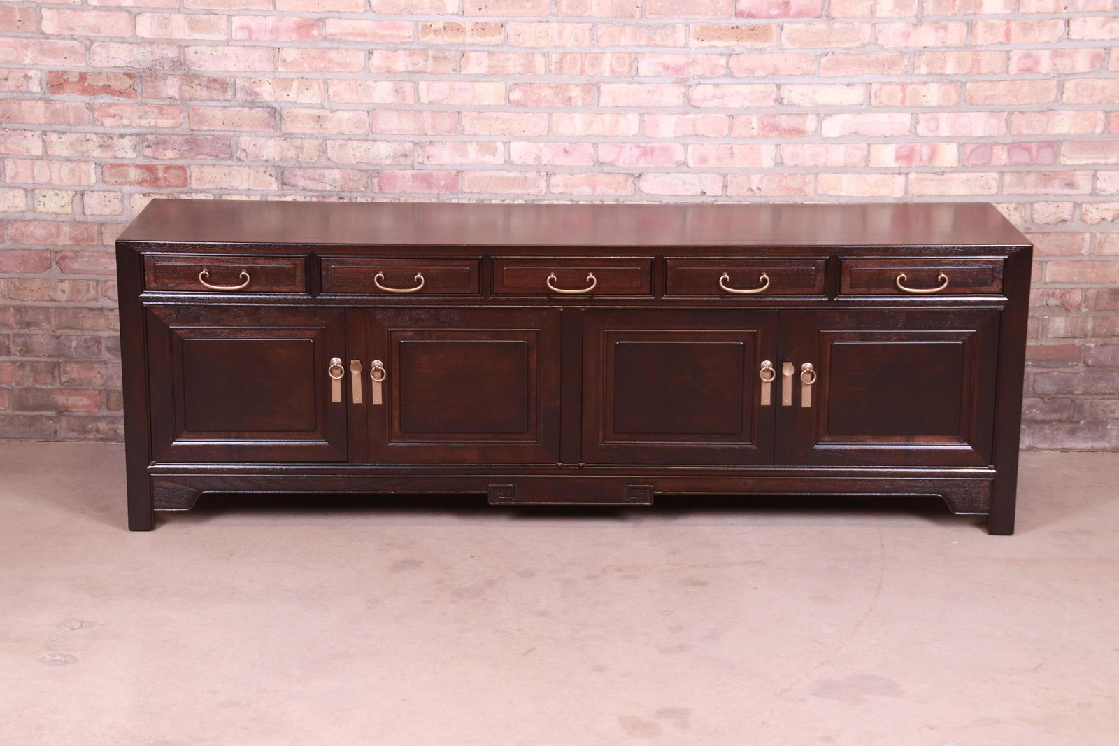 Michael Taylor for Baker Far East Collection Sideboard: An exceptional mid-century modern Hollywood Regency Chinoiserie low credenza sideboard or bar cabinet By Michael Taylor for Baker Furniture "Far East Collection" USA 1950s Carved walnut in onyx finish