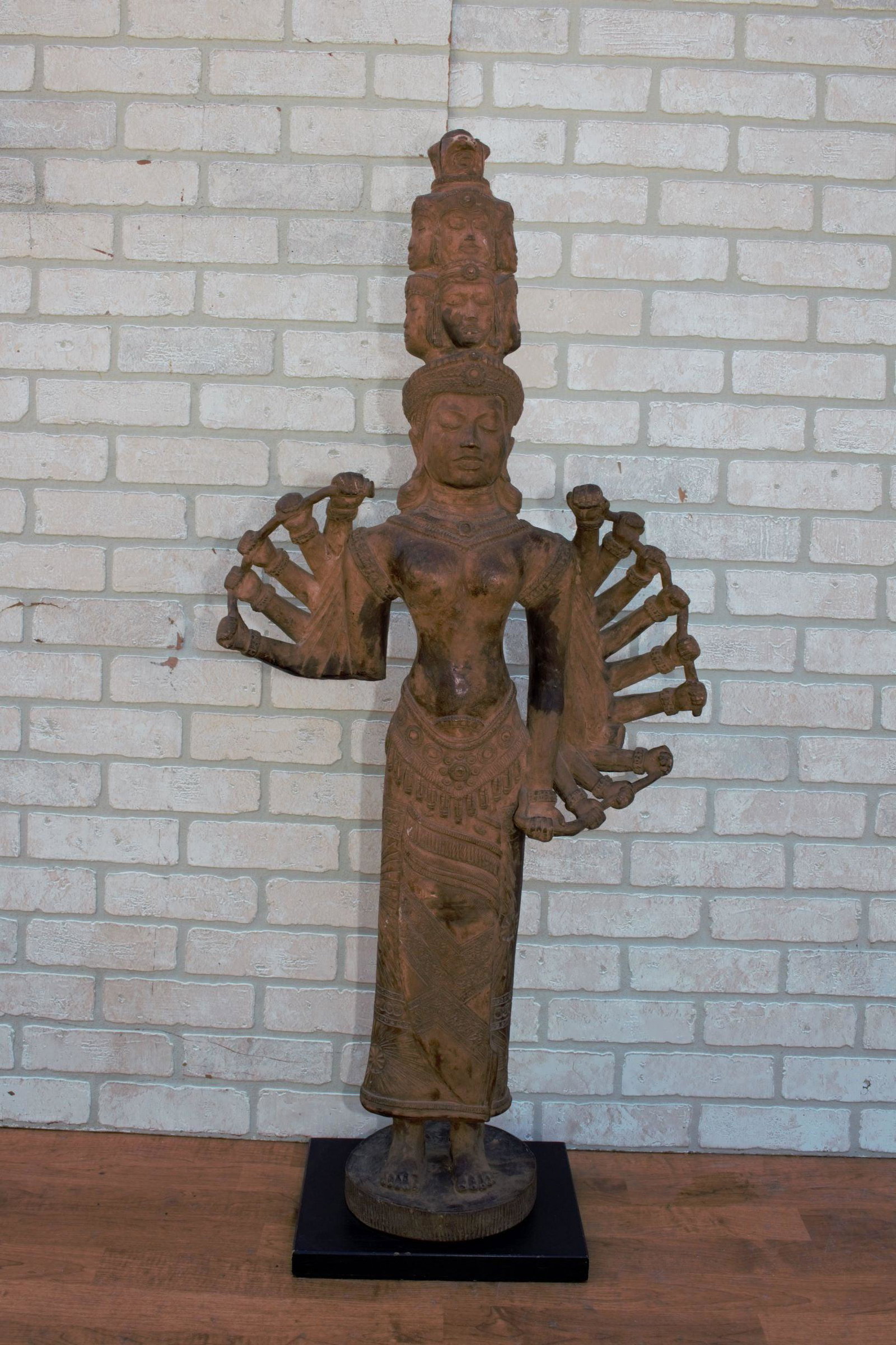 Antique Cambodian Terra Cotta Statue: Antique Cambodian Terra Cotta Statue 15 arm and 9 faces. Circa 1920 H 48 D 9.5 W 21 Good vintage condition The BIDHAUS Guarantee: Photos descriptions and estimates were prepared with the utmost c
