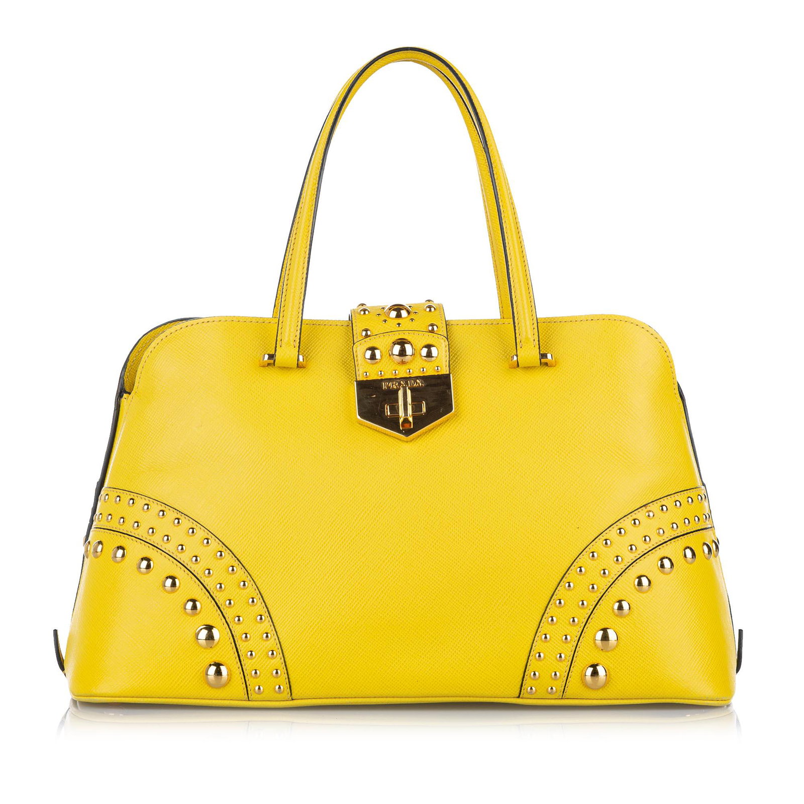 Authentic Prada Studded Saffiano Satchel: This item qualifies for FREE DOMESTIC SHIPPING to customers in the USA This satchel features a studded leather body rolled leather handles a detachable flat leather strap a top strap with turnlock clo