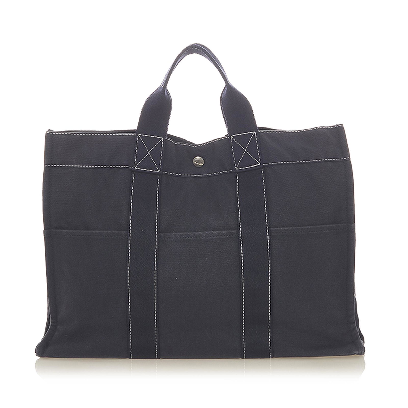 Authentic Hermes Fourre Tout MM: This item qualifies for FREE DOMESTIC SHIPPING to customers in the USA The Fourre Tout MM tote features a canvas body exterior front and back slip pockets flat handles an open top with a snap closure 