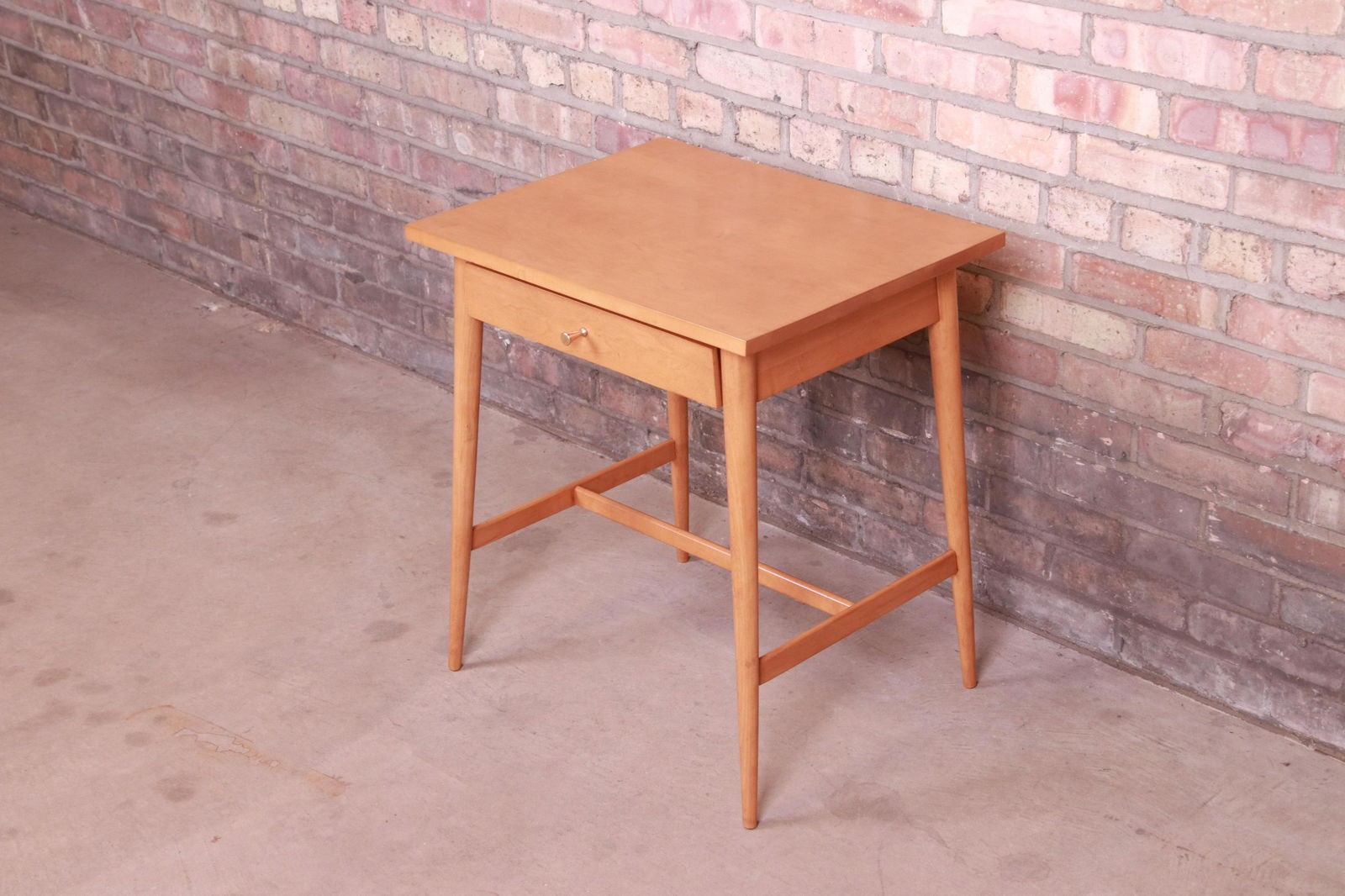 Paul McCobb Planner Group Solid Maple Nightstand Newly: A sleek and stylish mid-century modern nightstand or side table By Paul McCobb for Winchendon Furniture "Planner Group" USA 1950s Solid maple with original brass drawer pull. Measures: 22"W x 17"D x 2