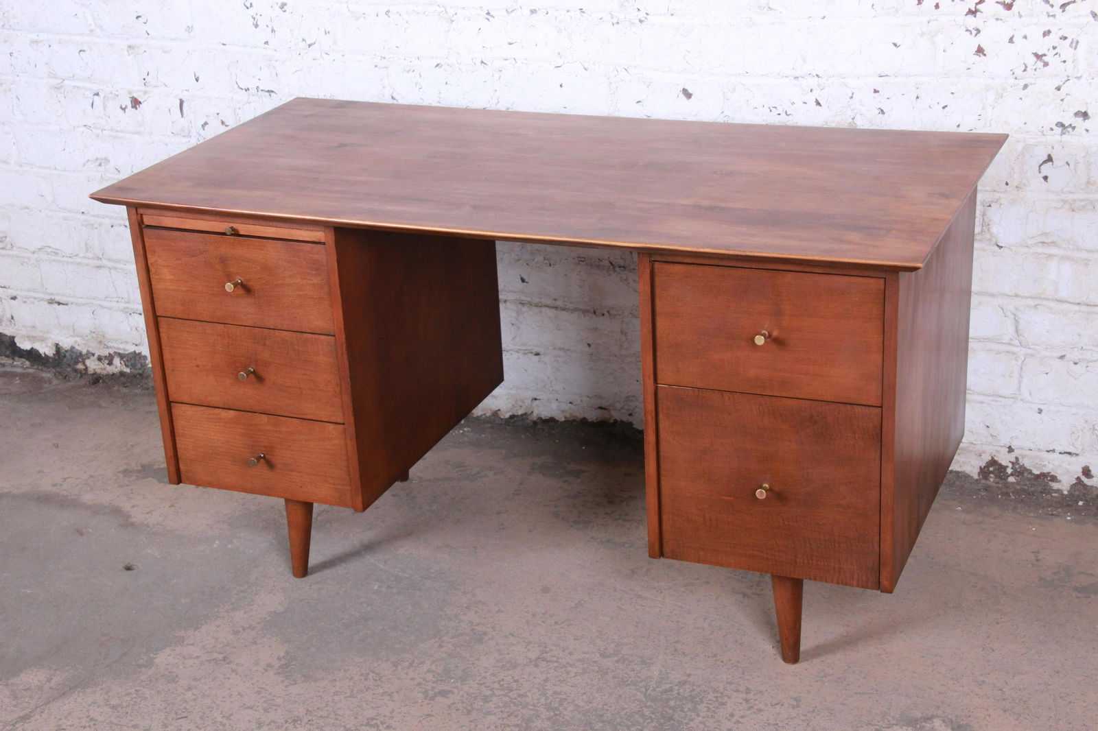 Paul McCobb Planner Group Mid-Century Modern Maple: An exceptional mid-century modern double pedestal executive writing desk Designed by Paul McCobb for Winchendon Furniture "Planner Group" USA 1950s Solid maple + brass hardware Measures: 53"W x 26"D x