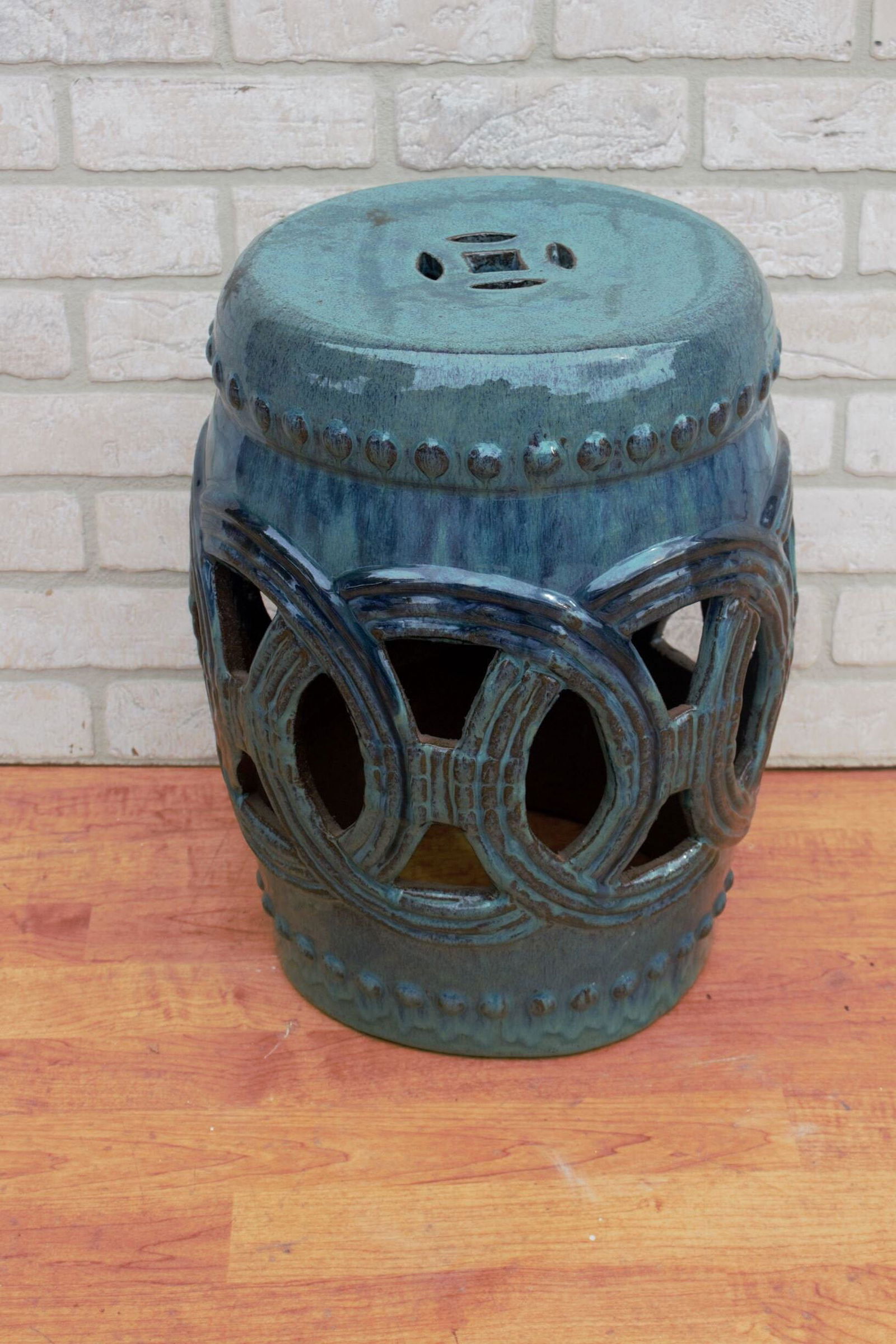 Ceramic Glazed Linked Forture Stool Side Table in: Ceramic Glazed Linked Forture Stool Side Table in Antique Green H 17” D 11” Good vintage condition The BIDHAUS Guarantee: Photos descriptions and estimates were prepared with the utmost ca