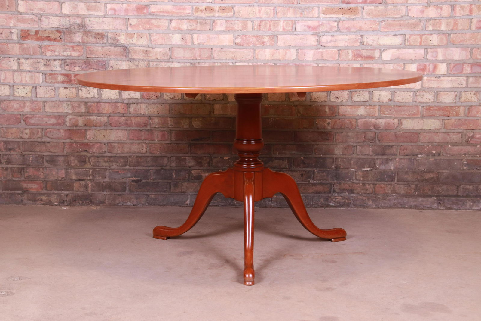 Eldred Wheeler Queen Anne Solid Cherry Wood Tilt Top: An exceptional Queen Anne style cherry wood tilt top pedestal breakfast table or dining table By Eldred Wheeler USA Late 20th Century Measures: 54"W x 54"D x 29.5"H. Newly refinished. Excellent condit