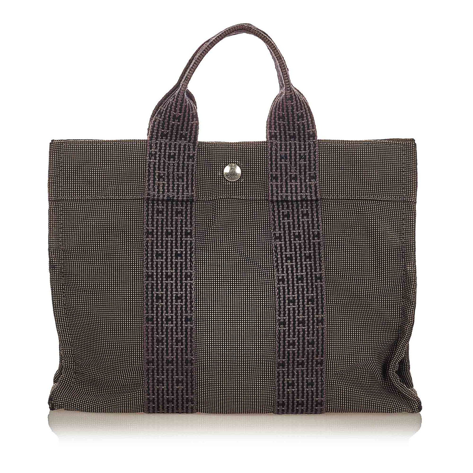 Authentic Hermes Fourre Tout PM: This item qualifies for FREE DOMESTIC SHIPPING to customers in the USA The Fourre Tout PM features a canvas body flat handles an open top with a snap closure and an interior zip compartment. Brand: He