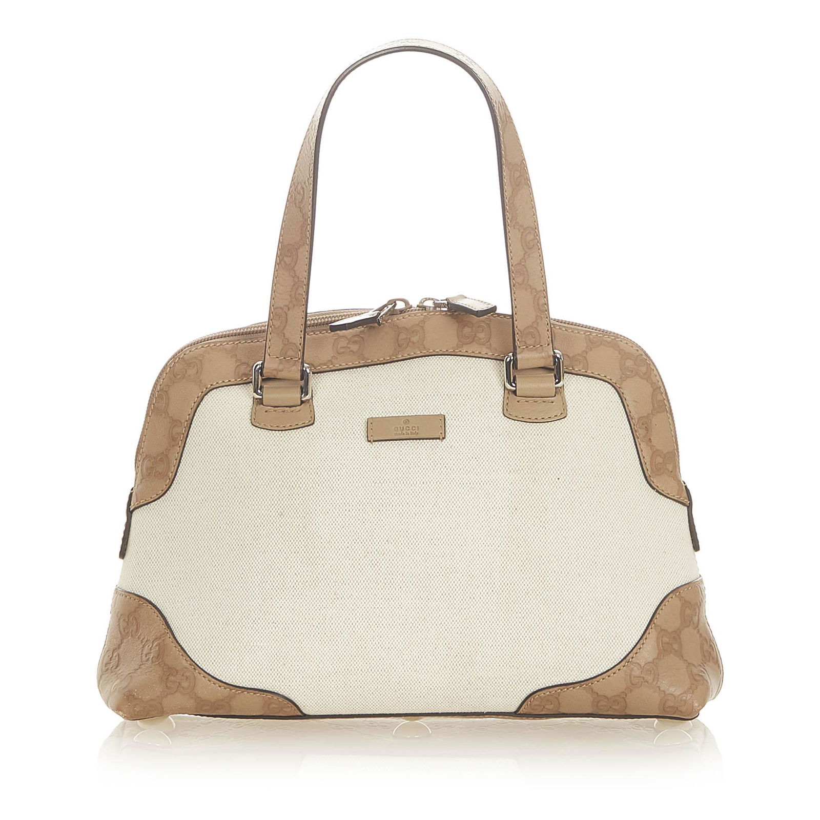 Authentic Gucci GG Canvas Handbag: This item qualifies for FREE DOMESTIC SHIPPING to customers in the USA This handbag features a canvas body with leather trim a flat leather handle a top zip closure and an interior zip and slip pocket