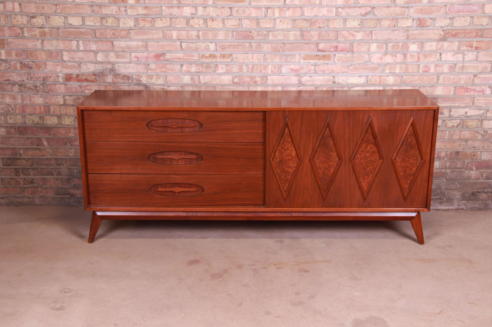 Mid-Century Modern Sculpted Walnut and Burl Wood: An exceptional mid-century modern sideboard credenza or long dresser USA Circa 1960s Sculpted walnut and burl wood with unique diamond front design. Measures: 77.5"W x 20"D x 32.25"H. Excellent origin