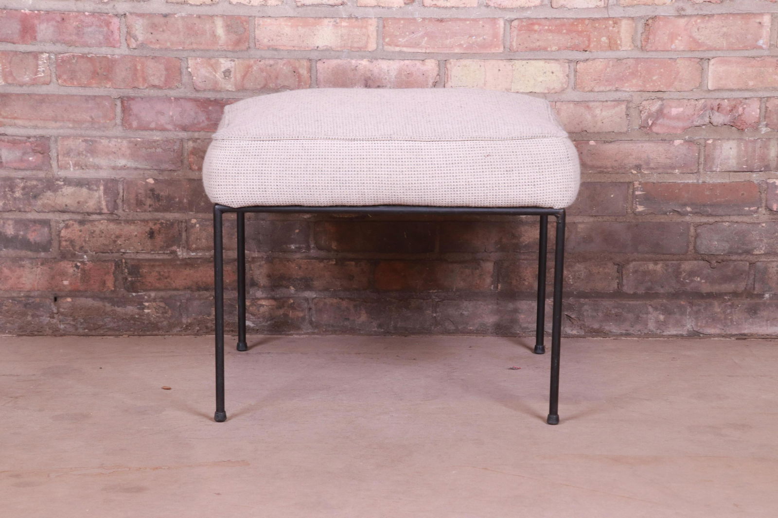 Paul McCobb Mid-Century Modern Upholstered Iron Stool: A sleek and stylish minimalist mid-century modern stool or ottoman By Paul McCobb for Winchendon Furniture "Planner Group" USA 1950s Iron legs with upholstered seat. Measures: 21.5"W x 21.5"D x 17.5"H
