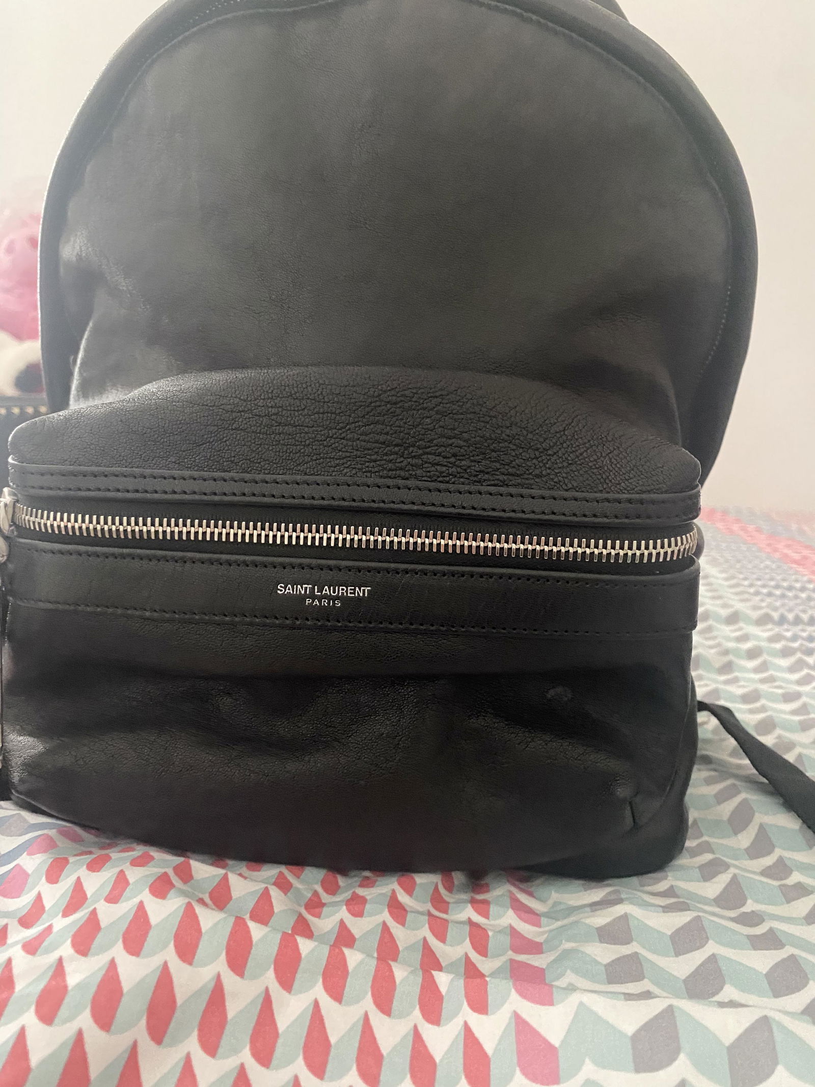 Authentic YSL City Leather Backpack: This item qualifies for FREE DOMESTIC SHIPPING to customers in the USA The City backpack features a lambskin leather body with nylon trim an exterior front zip compartment a flat top handle flat back