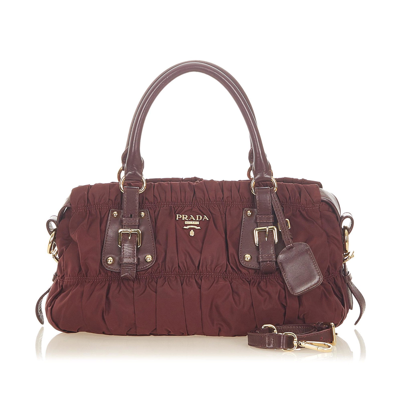 Authentic Prada Tessuto Gaufre Satchel: This item qualifies for FREE DOMESTIC SHIPPING to customers in the USA This satchel features a gathered nylon body rolled leather handles a flat leather strap a top zip closure and interior zip and sl