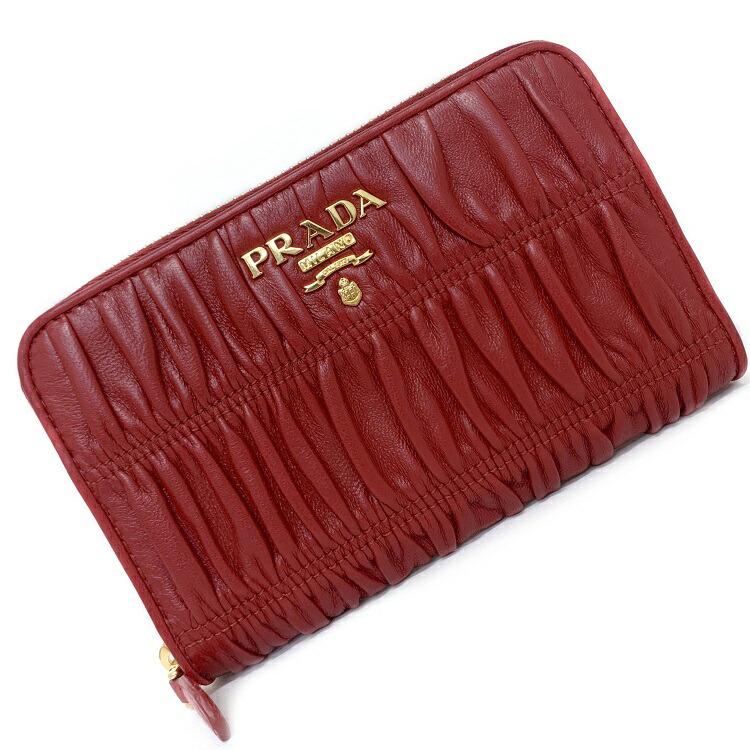 Authentic Prada zipper wallet red nappa waffle 1ML157: This item qualifies for FREE DOMESTIC SHIPPING to customers in the USA Brand: Prada Type: Wallet (bi-fold) Gender: Women Accessories: Box, Guarantee card Condition: Opened (never used) Material: Leath