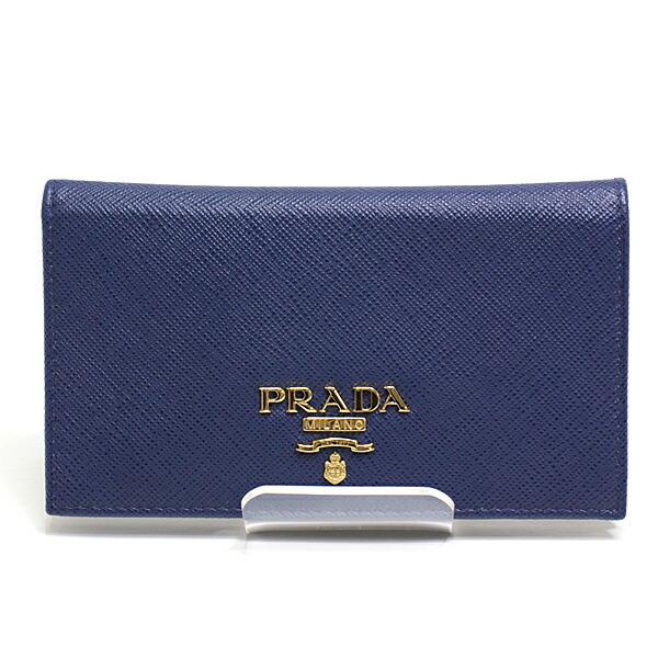 Authentic Prada bi-fold wallet 1MV020 blue saffiano: This item qualifies for FREE DOMESTIC SHIPPING to customers in the USA Brand: Prada Type: Bill wallet (bi-fold) Material: Leather Color: Blue Size (HxWxD): 7.5cm x 13.5cm x 1cm / 2.95'' x 5.31'' x 0.3