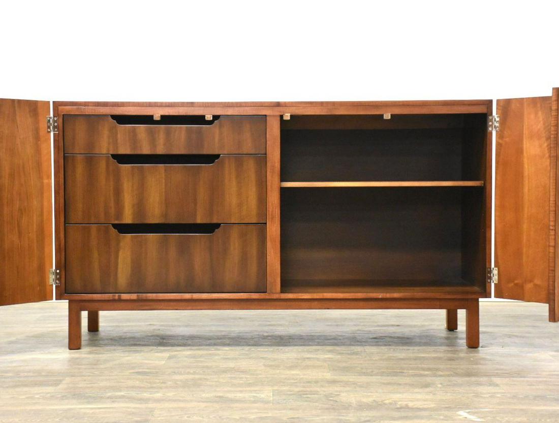 Bert England for Widdicomb Walnut Sidebord Credenza: A mid century modern walnut credenza sideboard to tv console designed by Bert England for John Widdicomb Orientation collection. Polished oversized brass bull ring pulls open the doors up to adjustabl