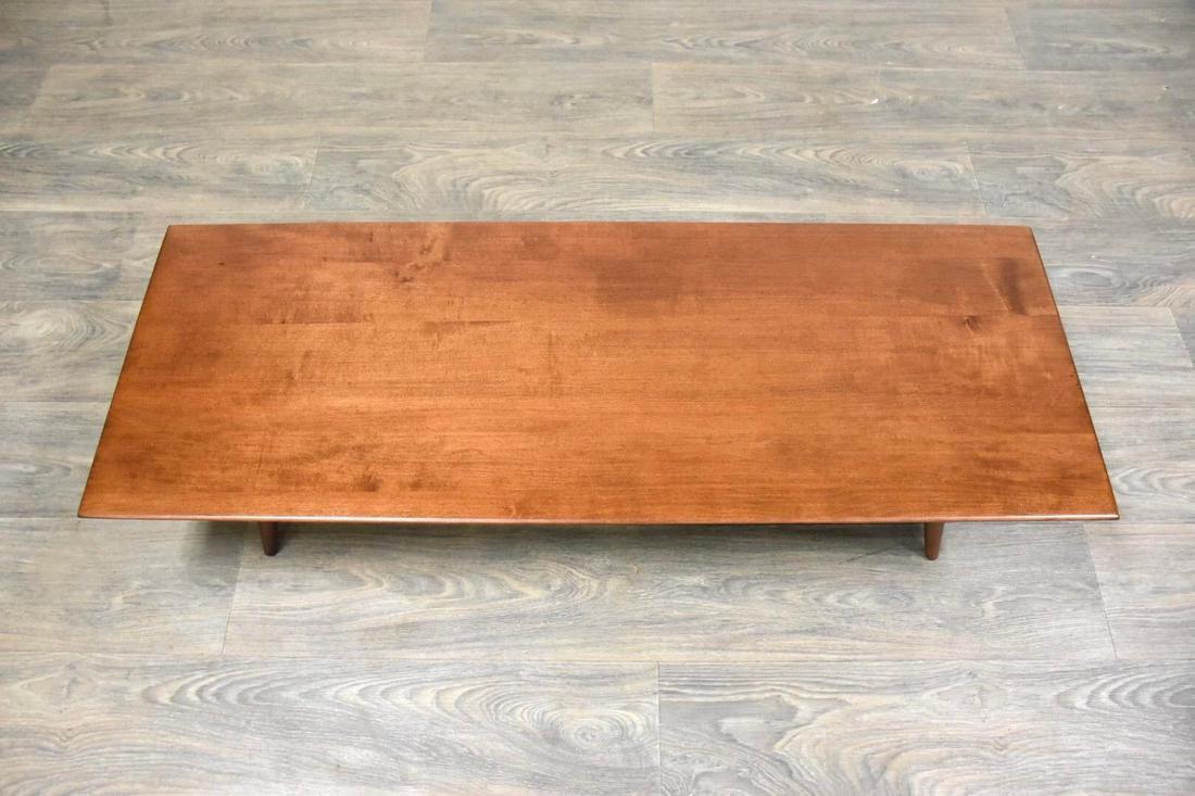 Paul McCobb Planner Group Coffee Table Bench: A mid century modern maple coffee table with tapered canted legs designed by Paul McCobb for Winchendon Furnitureâ€™s Planner Group. Professionally refinished. 48 wide. 18.125 deep. 10 tall. Dime