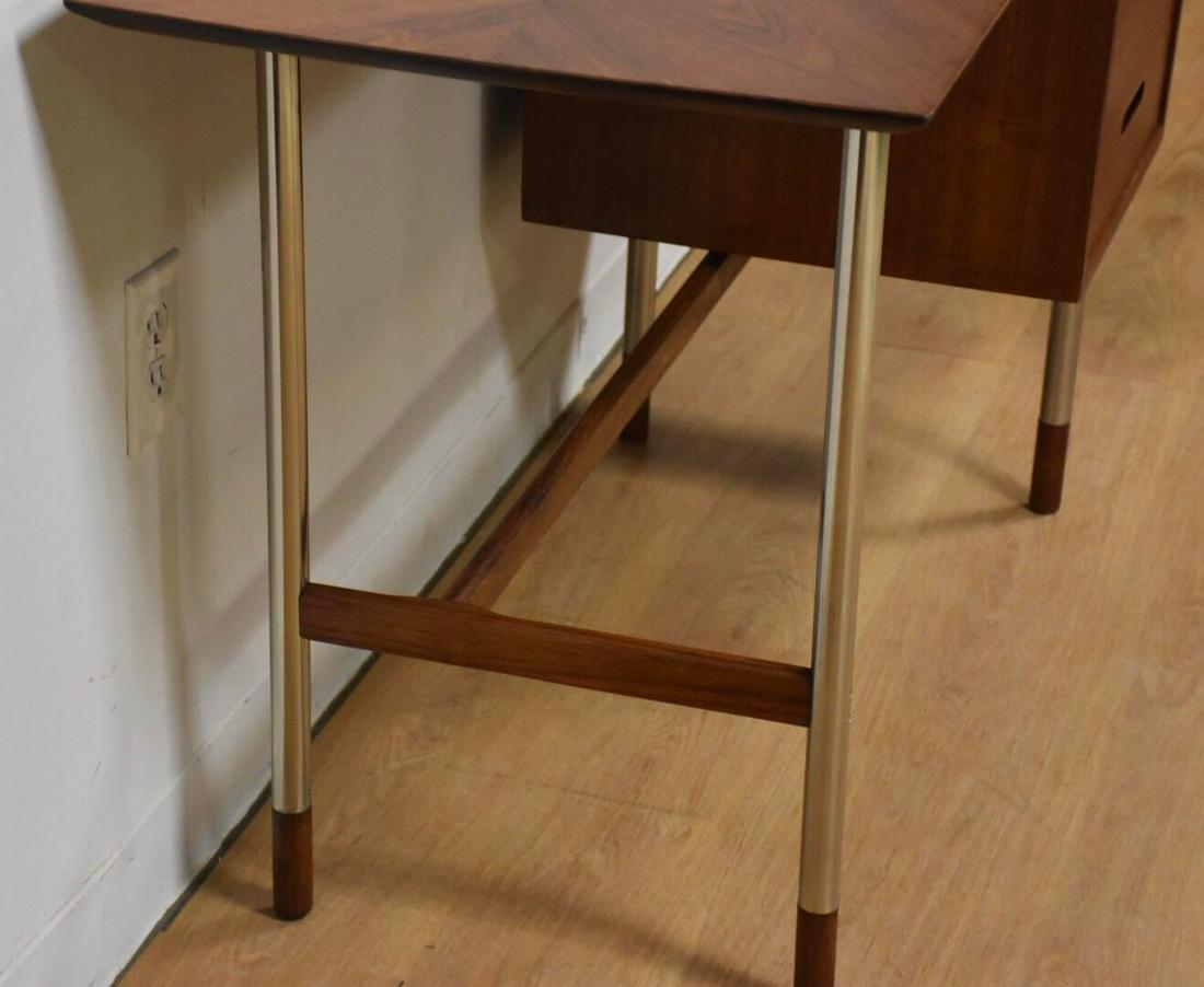 Jack Cartwright for Founders Walnut and Steel Desk: This spectacular mid century modern walnut desk has a polished steel frame designed by Jack Cartwright for Founders Furniture. With a finished back you can place this piece in the center of your moder