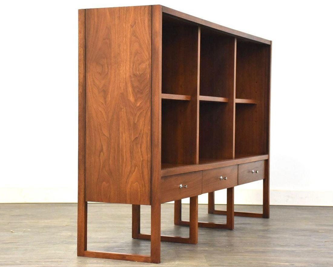 Paul McCobb for Lane Delineator Bookcase: A mid century modern walnut bookcase with adjustable shelves designed by Paul McCobb for Laneâ€™s Delineator collection. Steel drawer pulls. Professionally restored. 54.125 wide. 13 deep. 36.125 