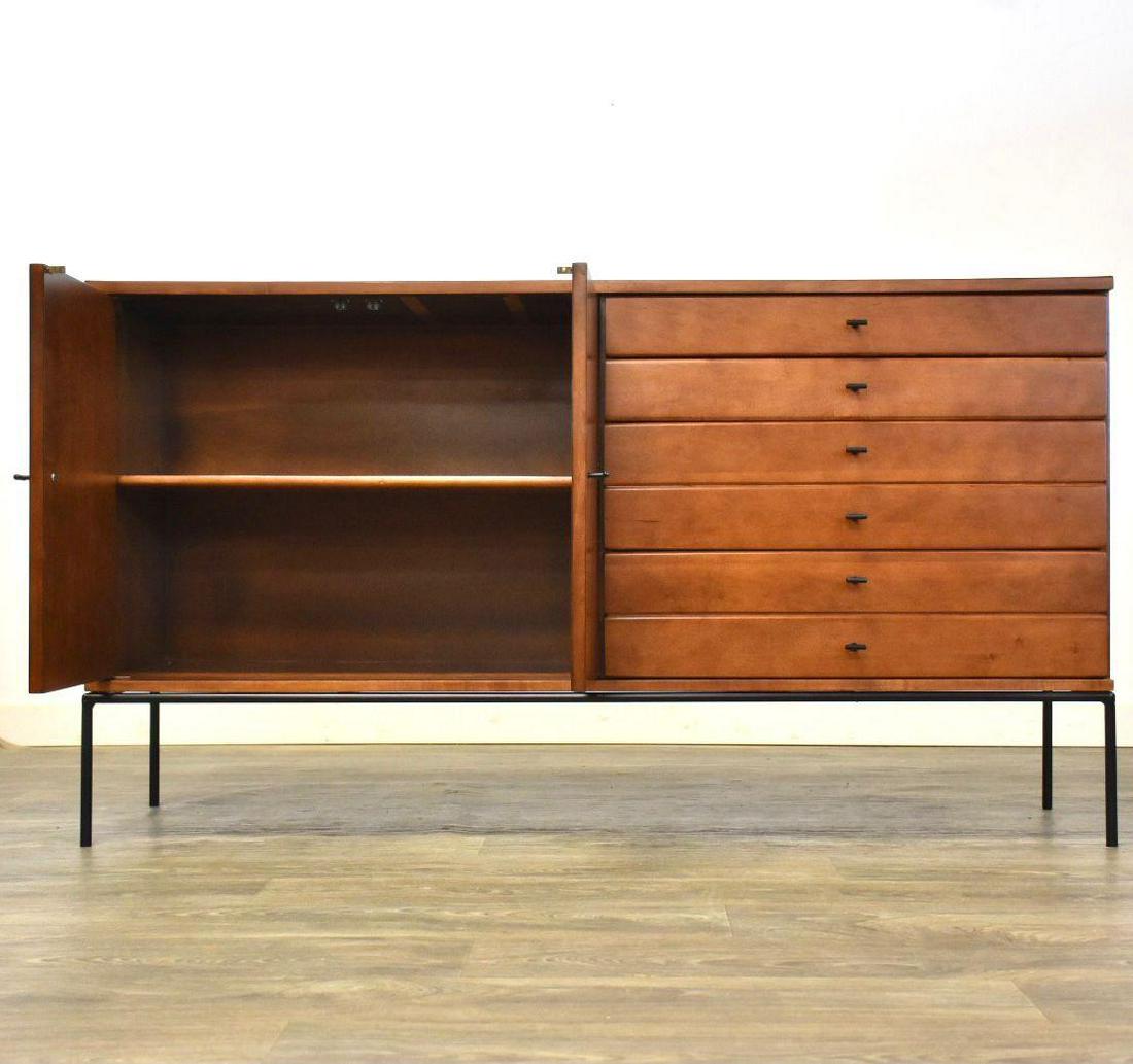Paul McCobb Planner Group Style Credenza: A mid century modern maple credenza with a black formica top black iron base and black iron T pulls in the manner of Paul McCobb for Planner Group. Unmarked. Professionally refinished. 59.75 wide. 18
