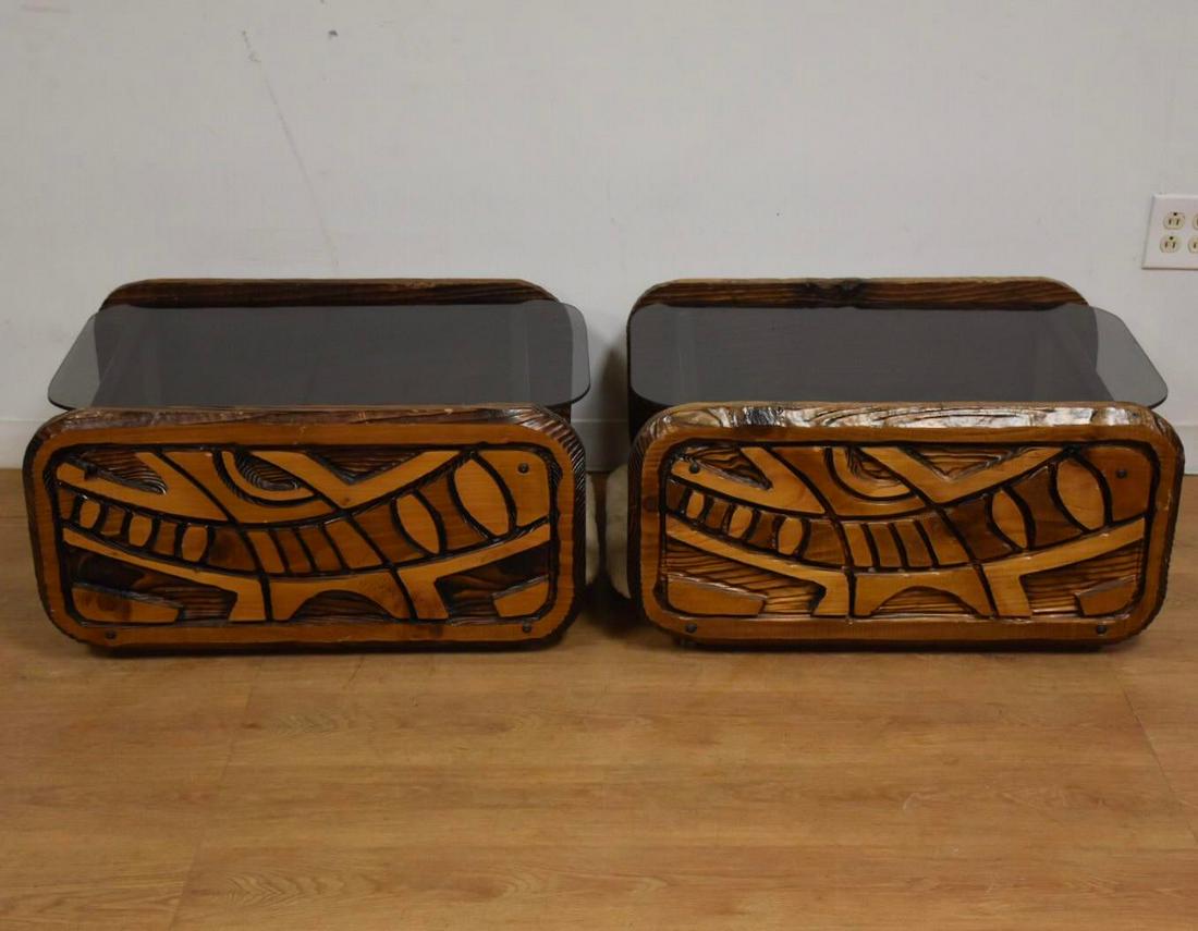 1980s Astract Router Cut End Tables - a Pair: A pair of mid century style end tables with beige upholstered lower shelves and smoked glass top shelves made of free handed router cut and fire charred abstract pine sides. 23 wide. 30 deep. 15 tall.