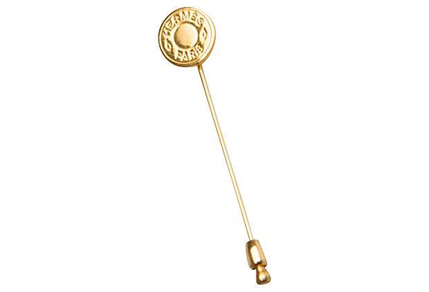 Hermes Gold Clou de Selle Pin: Hermes Gold Clou de Selle Pin Condition: Excellent Era: Contemporary Dimensions: 2.5" L x 0.5" H Materials: metal Color: gold Hermes Paris goldtone clou de selle pin. Comes with velvet pouch. The BI