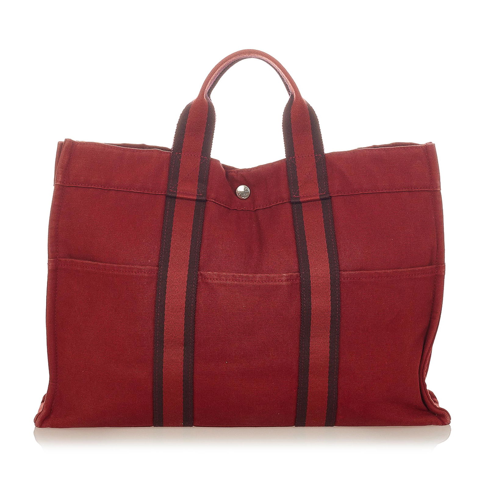 Hermes Fourre Tout MM: Hermes Fourre Tout MM The Fourre Tout MM tote features a canvas body exterior front and back slip pockets flat handles an open top with a snap closure and an interior zip compartment. Brand: Hermes Mo
