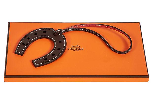 Hermes Brown Horseshoe Bag Charm: Hermes Brown Horseshoe Bag Charm Condition: New Era: Contemporary; 2000s Dimensions: 3" L x 9" H Materials: leather/horsehair Color: brown/brick Hermes horseshoe bag charm in brown Swift leather with