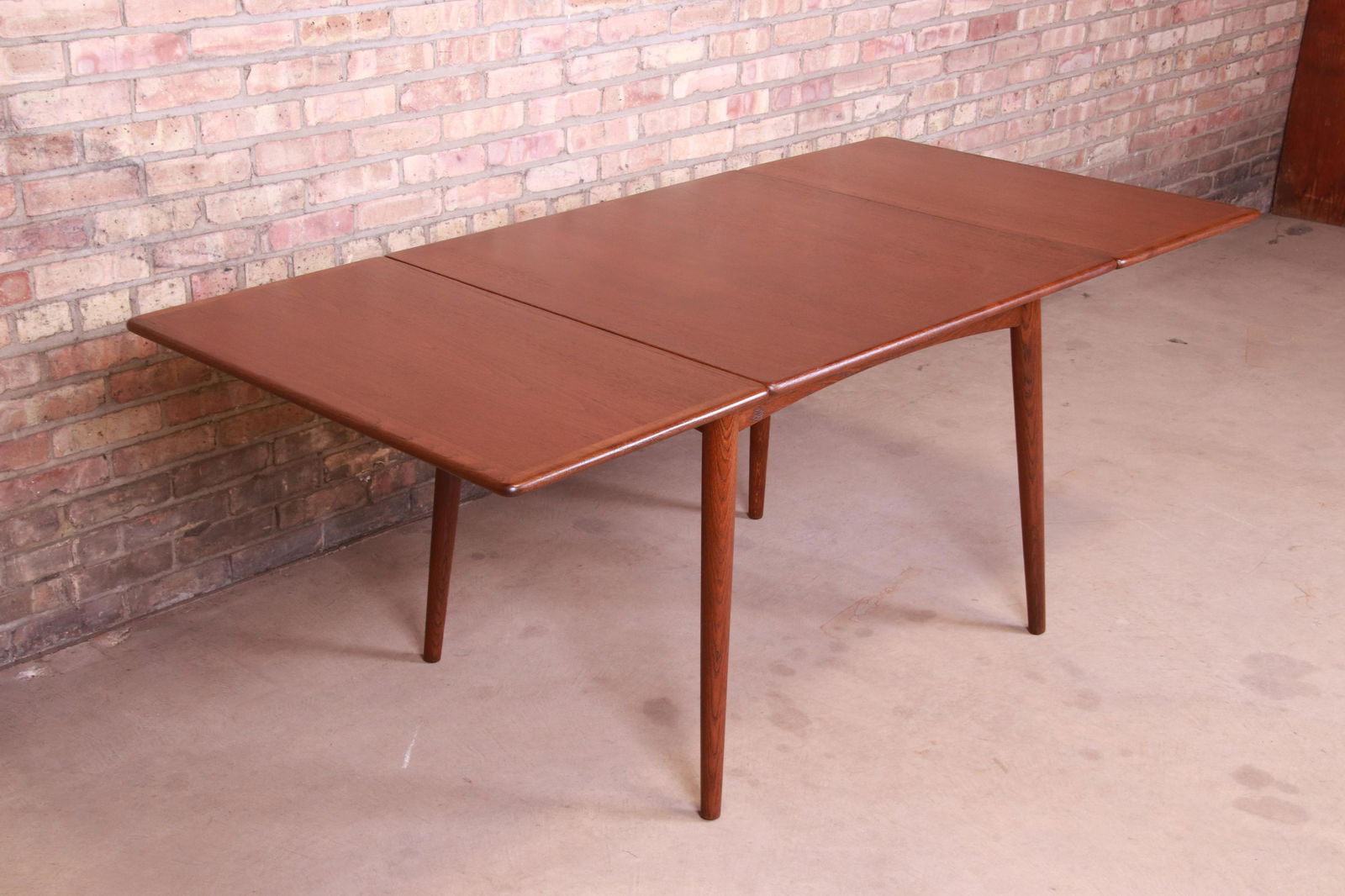 Hans J. Wegner for Andreas Tuck Danish Modern Teak: Hans J. Wegner for Andreas Tuck Danish Modern Teak Drop-Leaf Dining Table Newly Refinished A rare and exceptional Danish Modern drop-leaf dining table By Hans J. Wegner for Andreas Tuck Denmark 1950s