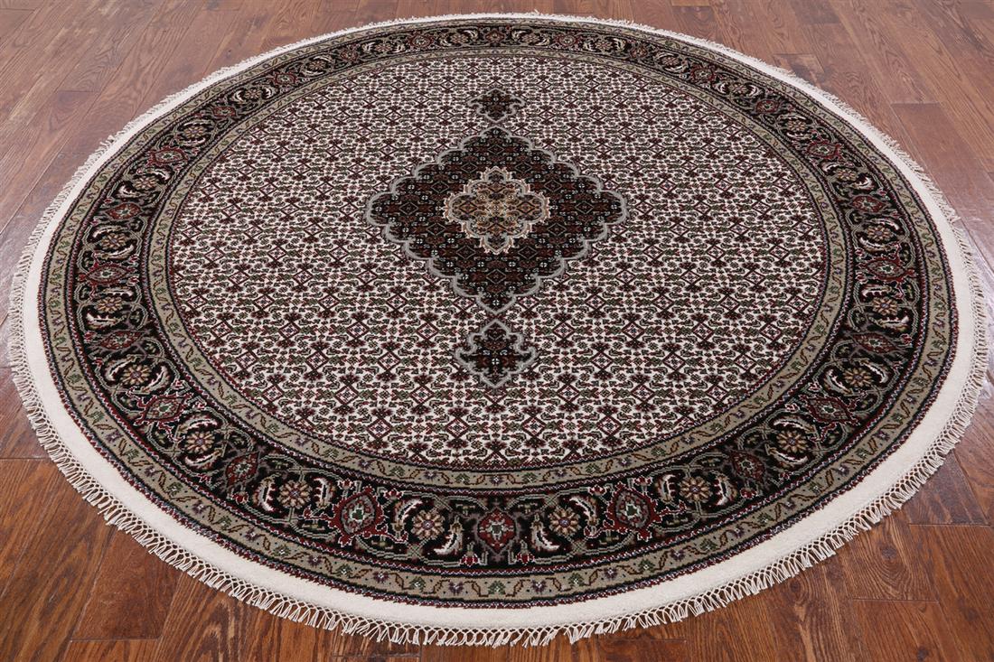 7' Round Persian Tabriz Wool & Silk Hand Knotted Rug: 7' Round Persian Tabriz Wool & Silk Hand Knotted Rug Design: Tabriz Exact Size: 6\ 8 X 6\ 8 Style: Persian Foundation: Cotton Pile: Wool & Silk Weave: Hand-knotted Age: New The BIDHAUS Guarantee: All